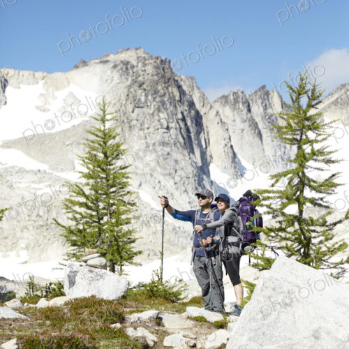 Couple hiking in remote mountains Couple hiking in remote mountains