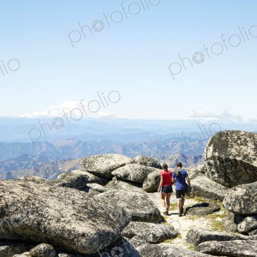 Couple hiking on rocky hilltop Couple hiking on rocky hilltop