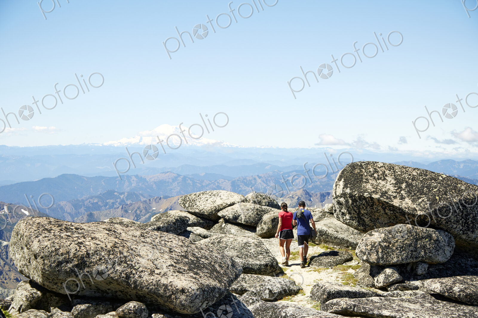 Couple hiking on rocky hilltop