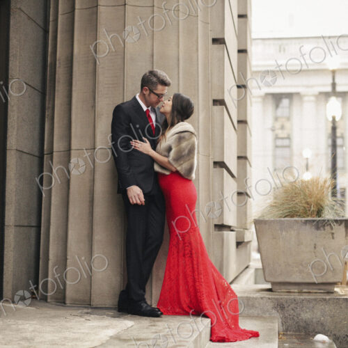 Couple in evening dress outside in wet weather in city Couple in evening dress outside in wet weather in city