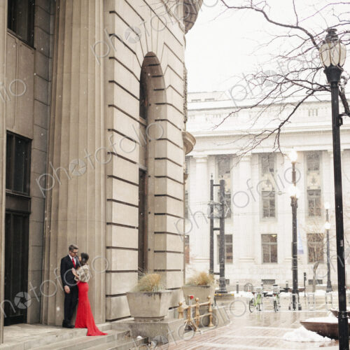 Couple in evening dress outside in wet weather in city Couple in evening dress outside in wet weather in city