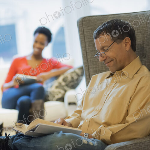 Couple relaxing at home reading Couple relaxing at home reading