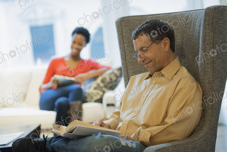 Couple relaxing at home reading