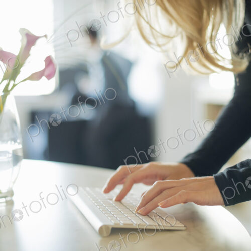 Couple relaxing at home, woman using keyboard Couple relaxing at home, woman using keyboard