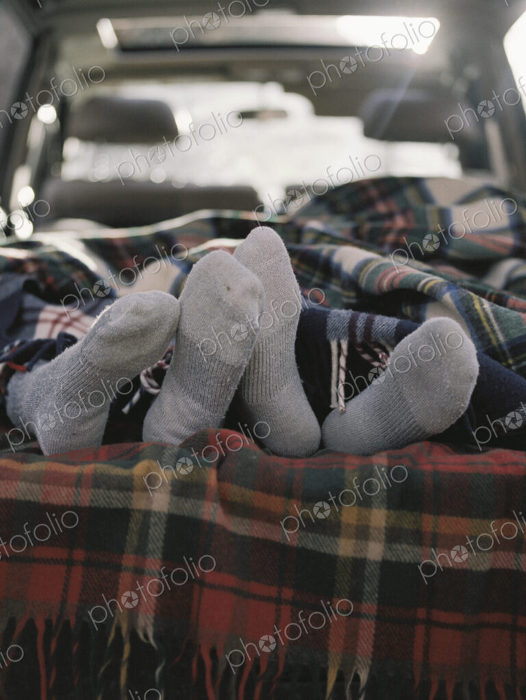 Couple sleeping in the back of their car.