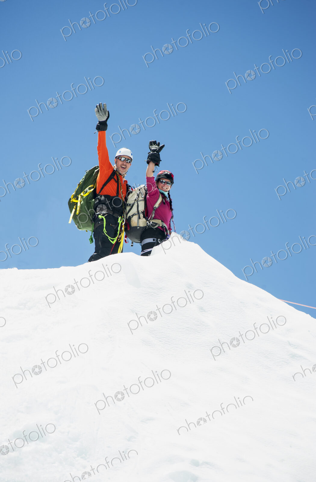 Couple waving on snowy mountain, Everest, Khumbu region, Nepal