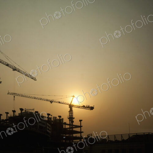 Crane on construction site at sunset. Crane on construction site at sunset.