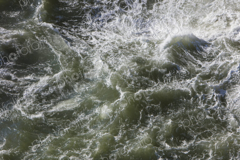 Crashing waves and ocean surf from above