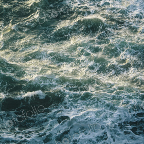 Crashing waves and surf, green and turquoise colours in the ocean, view from above. Crashing waves and surf, green and turquoise colours in the ocean, view from above.