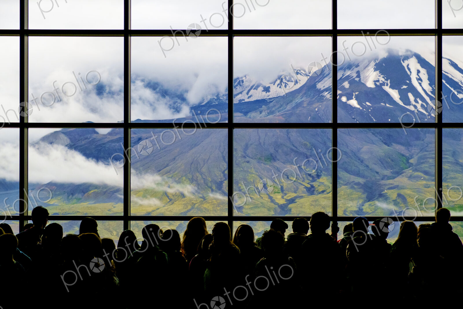 Crowd at window with scenic view of mountain