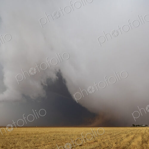 Cumulonimbus Clouds meeting the ground on the horizon, a dark shape and lighter clouds… Cumulonimbus Clouds meeting the ground on the horizon, a dark shape and lighter clouds…
