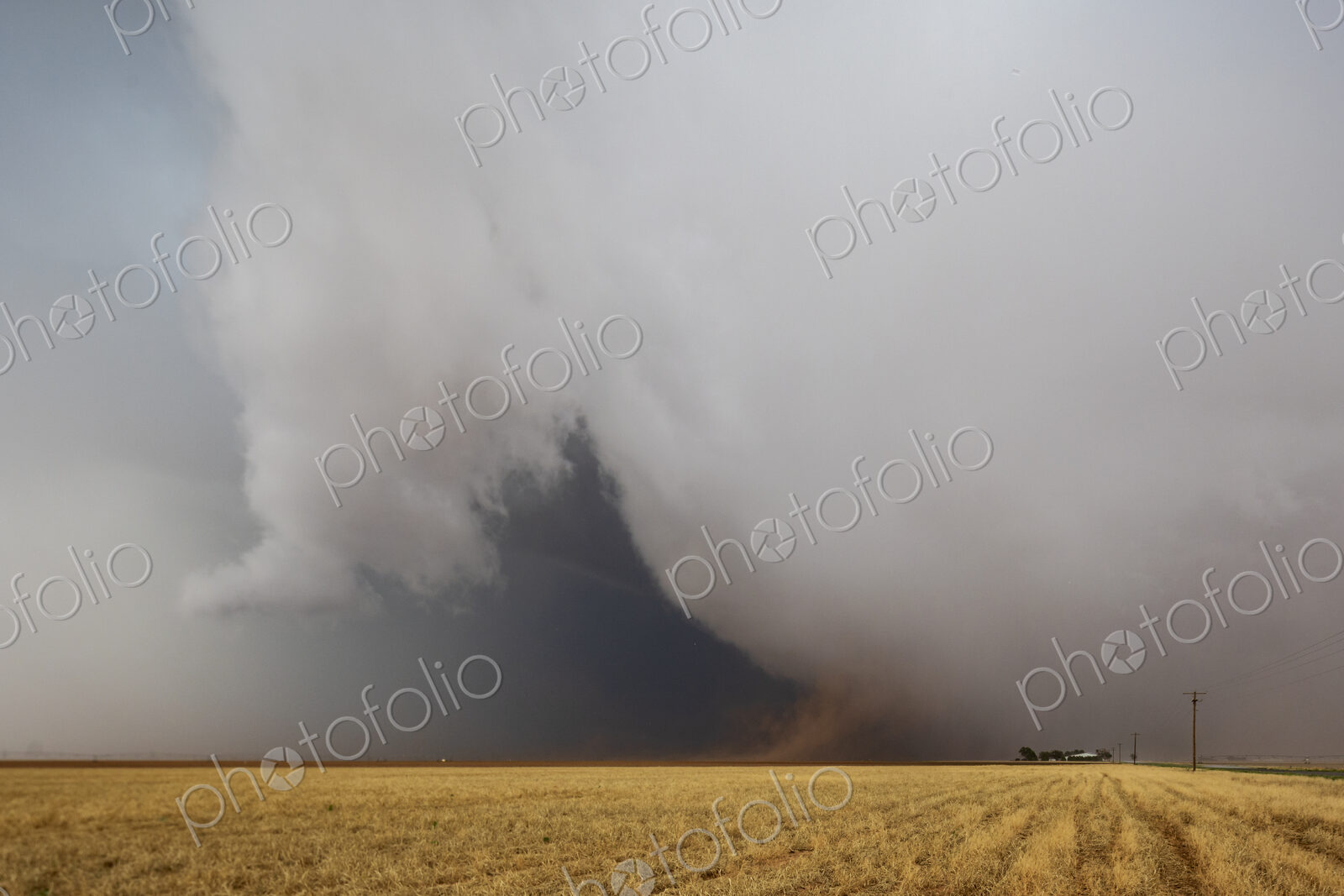 Cumulonimbus Clouds meeting the ground on the horizon, a dark shape and lighter clouds…