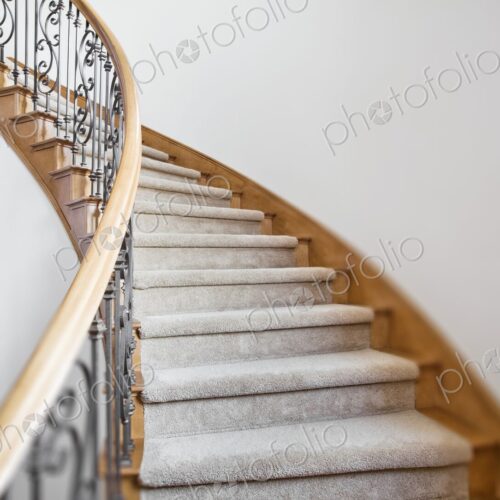 Curved staircase leads to the second story in a house.