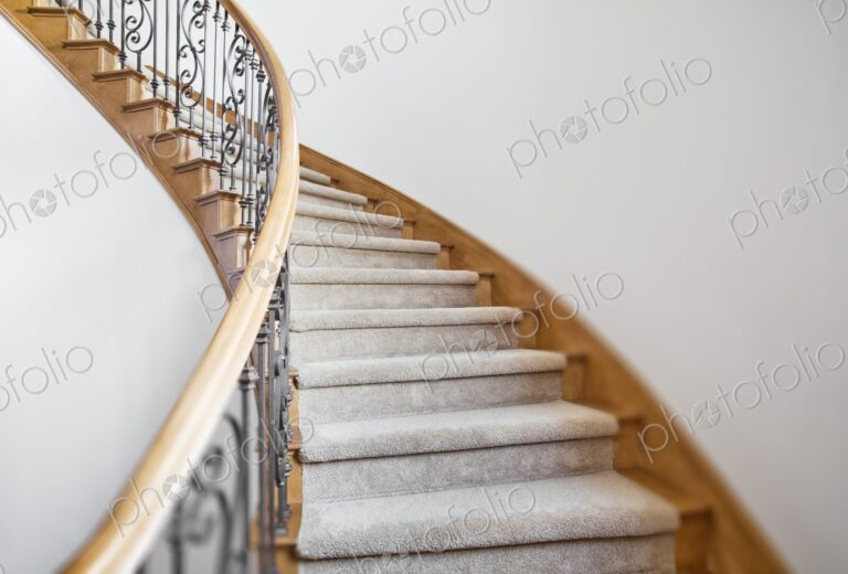 Curved staircase leads to the second story in a house.