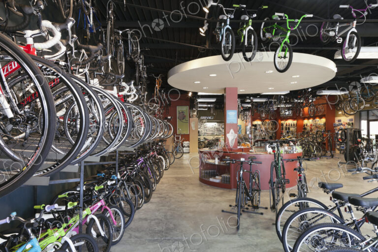 Cycle repair shop interior, rows of bicycles.
