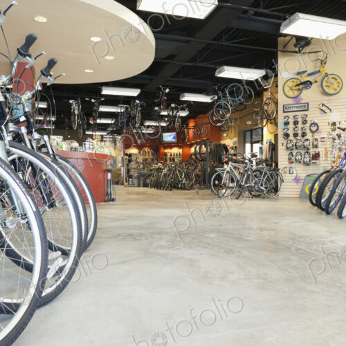 Cycle repair shop interior, rows of bicycles.