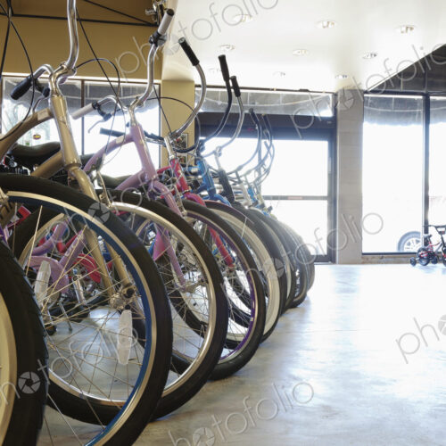 Cycle repair shop interior, rows of bicycles.