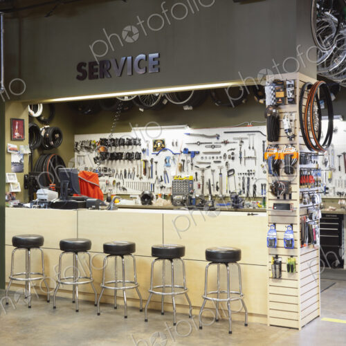 Cycle repair shop interior, tool boards and tools at a service counter. Cycle repair shop interior, tool boards and tools at a service counter.