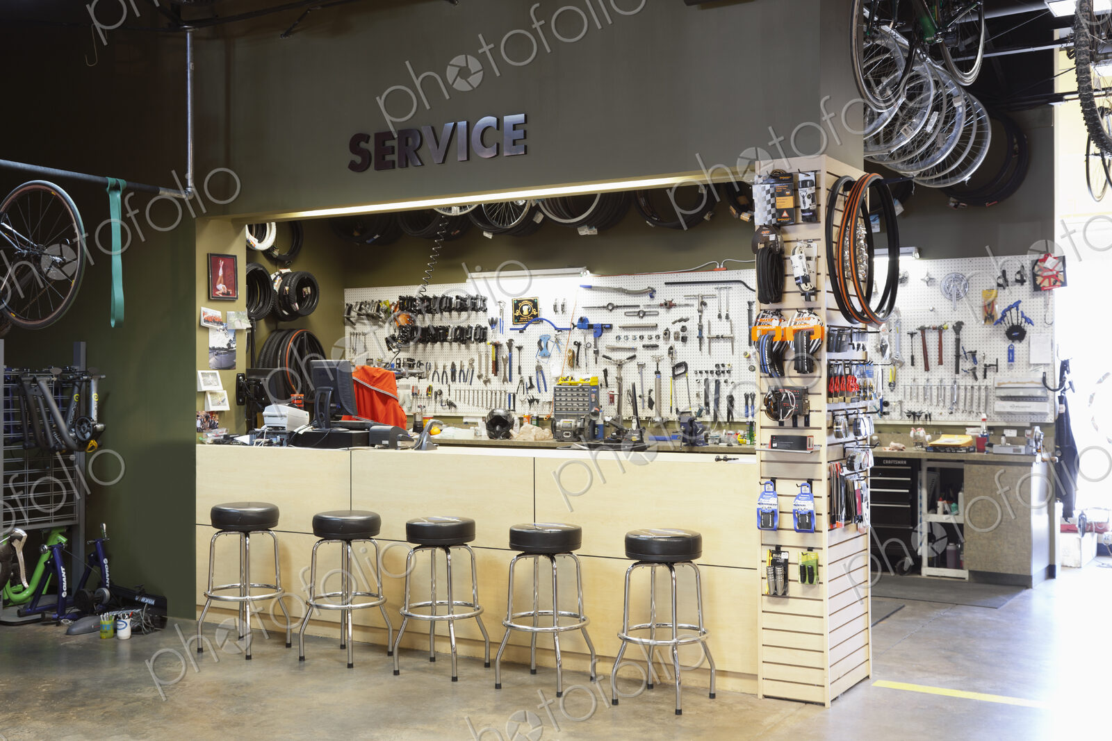 Cycle repair shop interior, tool boards and tools at a service counter.