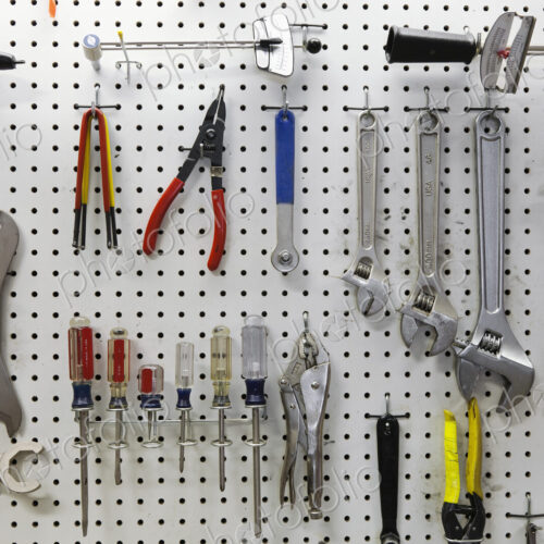 Cycle repair shop interior, tool boards and tools at a service counter. Cycle repair shop interior, tool boards and tools at a service counter.