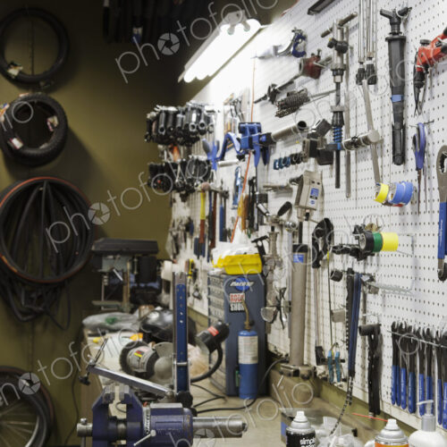 Cycle repair shop interior, tool boards and tools at a service counter. Cycle repair shop interior, tool boards and tools at a service counter.