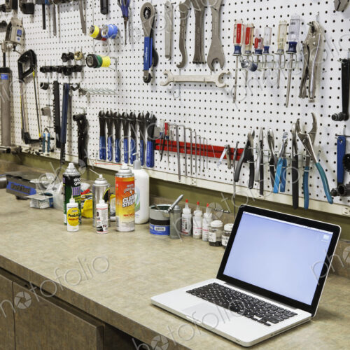 Cycle repair shop interior, tool boards and tools at a service counter. Cycle repair shop interior, tool boards and tools at a service counter.