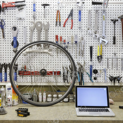 Cycle repair shop interior, tool boards and tools at a service counter. Cycle repair shop interior, tool boards and tools at a service counter.