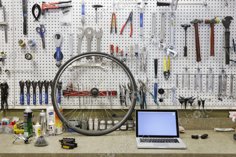 Cycle repair shop interior, tool boards and tools at a service counter.