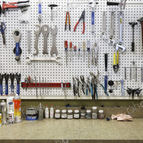 Cycle repair shop interior, tool boards and tools at a service counter. Cycle repair shop interior, tool boards and tools at a service counter.