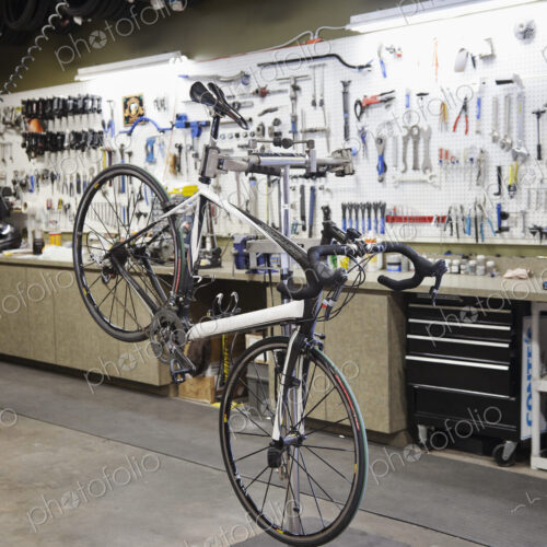 Cycle repair shop interior, tool boards and tools at a service counter. Cycle repair shop interior, tool boards and tools at a service counter.