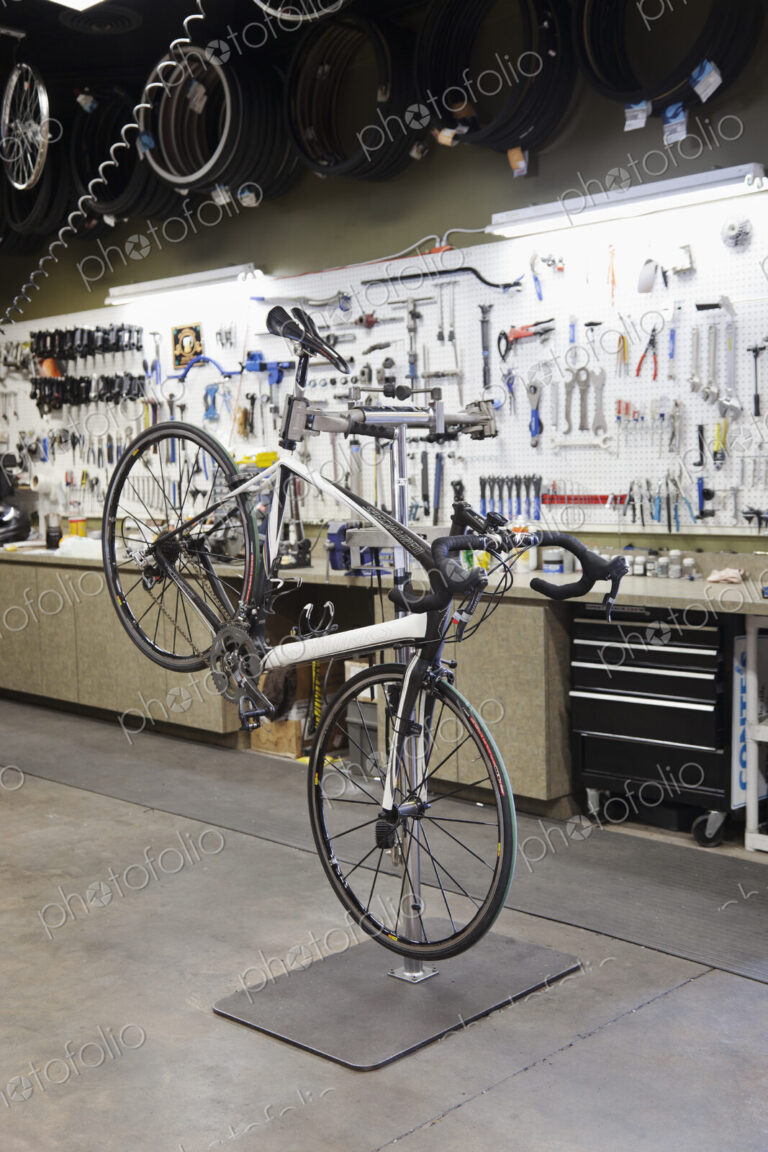 Cycle repair shop interior, tool boards and tools at a service counter.