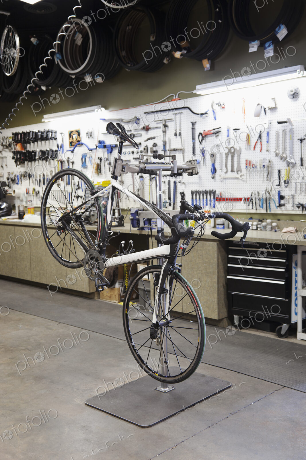 Cycle repair shop interior, tool boards and tools at a service counter.