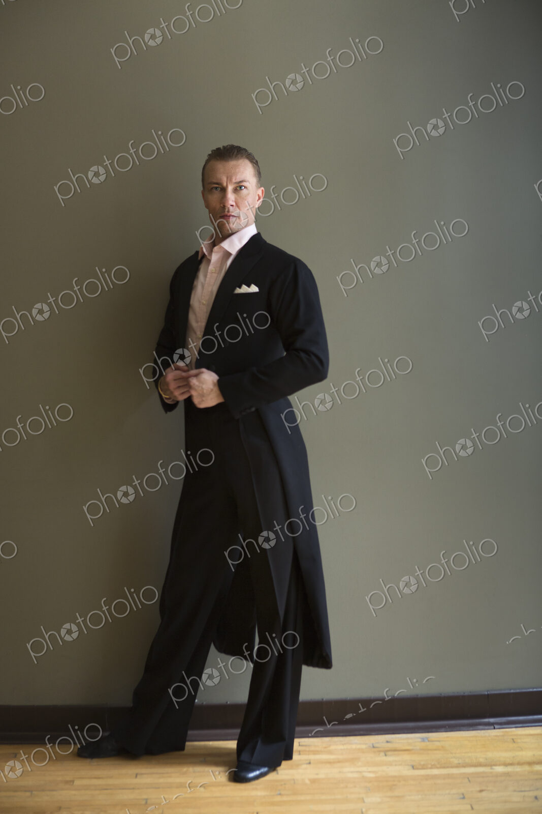 Dancer in dance studio. A man in a frock coat.