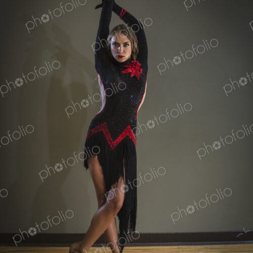 Dancer in dance studio. A woman in a black dress.