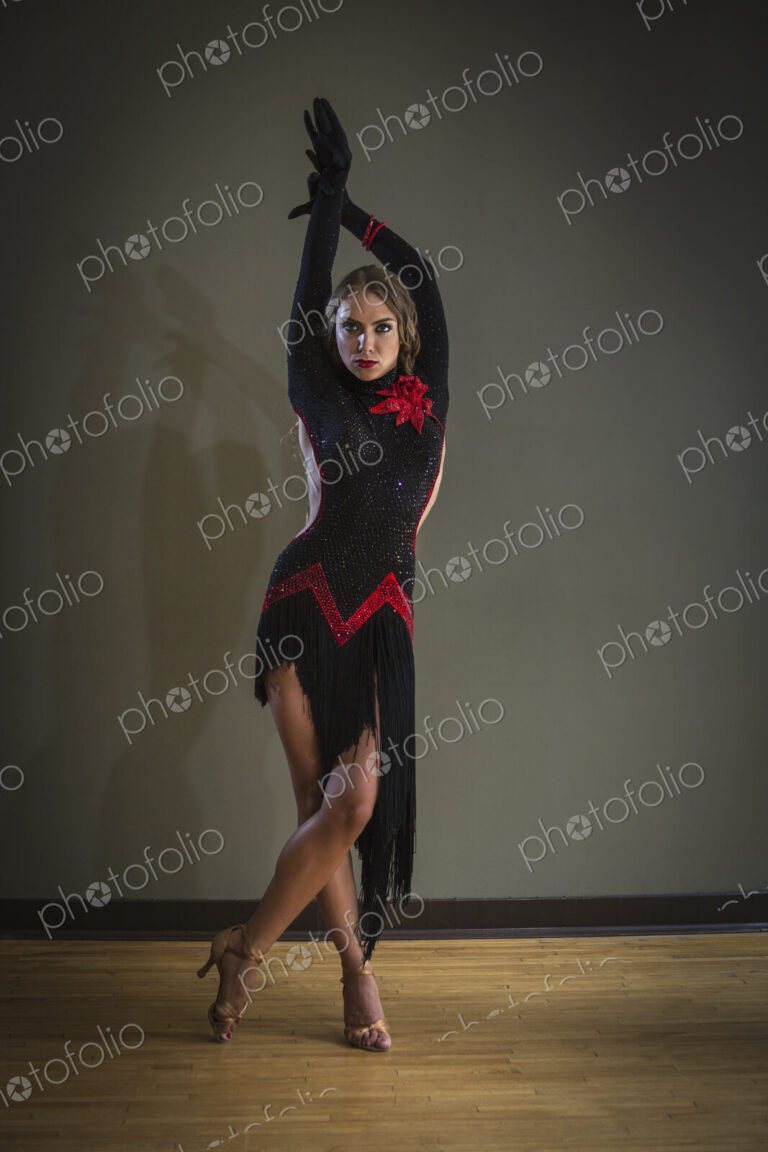 Dancer in dance studio. A woman in a black dress.