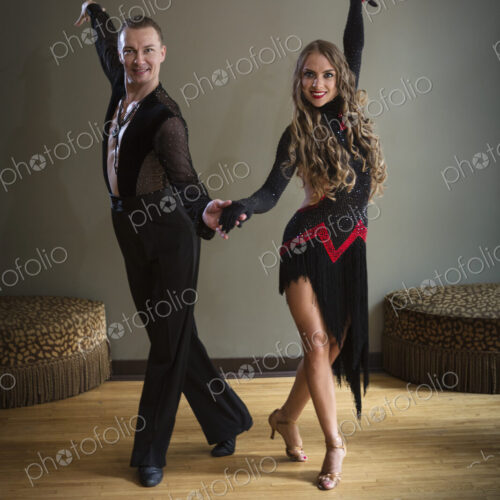 Dancers in dance studio. A man and woman side by side.