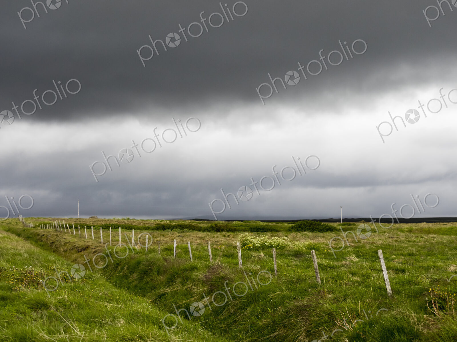 Dark rain clouds over farmland.