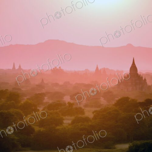 Dawn and mist in the air above temple on the plain in Mandalay. Dawn and mist in the air above temple on the plain in Mandalay.