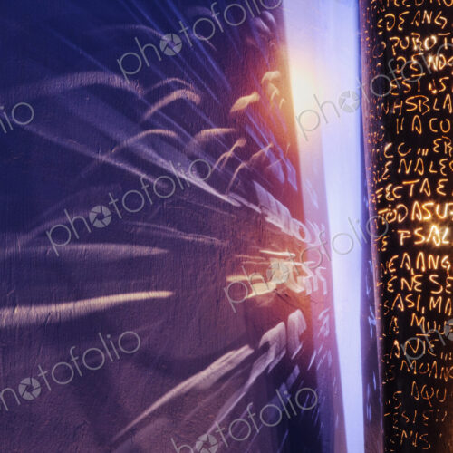 Designer Light Fixture, close up of a surface covered in letters, and light rays on a… Designer Light Fixture, close up of a surface covered in letters, and light rays on a…