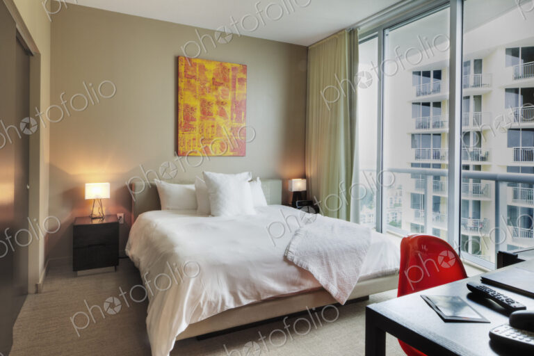 Desk and bed in hotel room