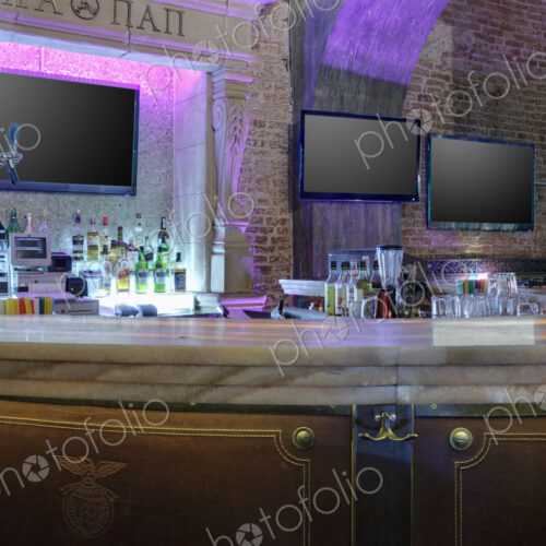 Detail of bar area with TV screens in a restaurant.