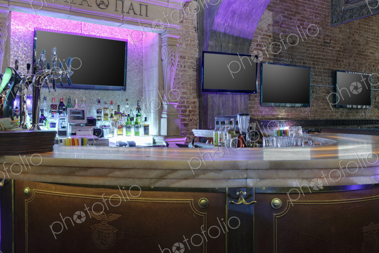 Detail of bar area with TV screens in a restaurant.