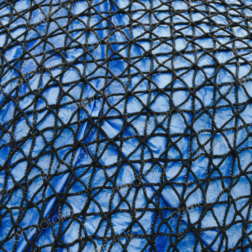 Detail of commercial fish net covering blue tarpaulin