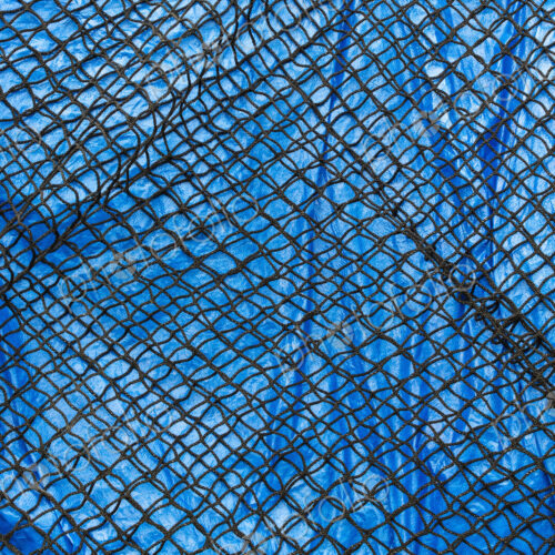 Detail of commercial fish net covering blue tarpaulin