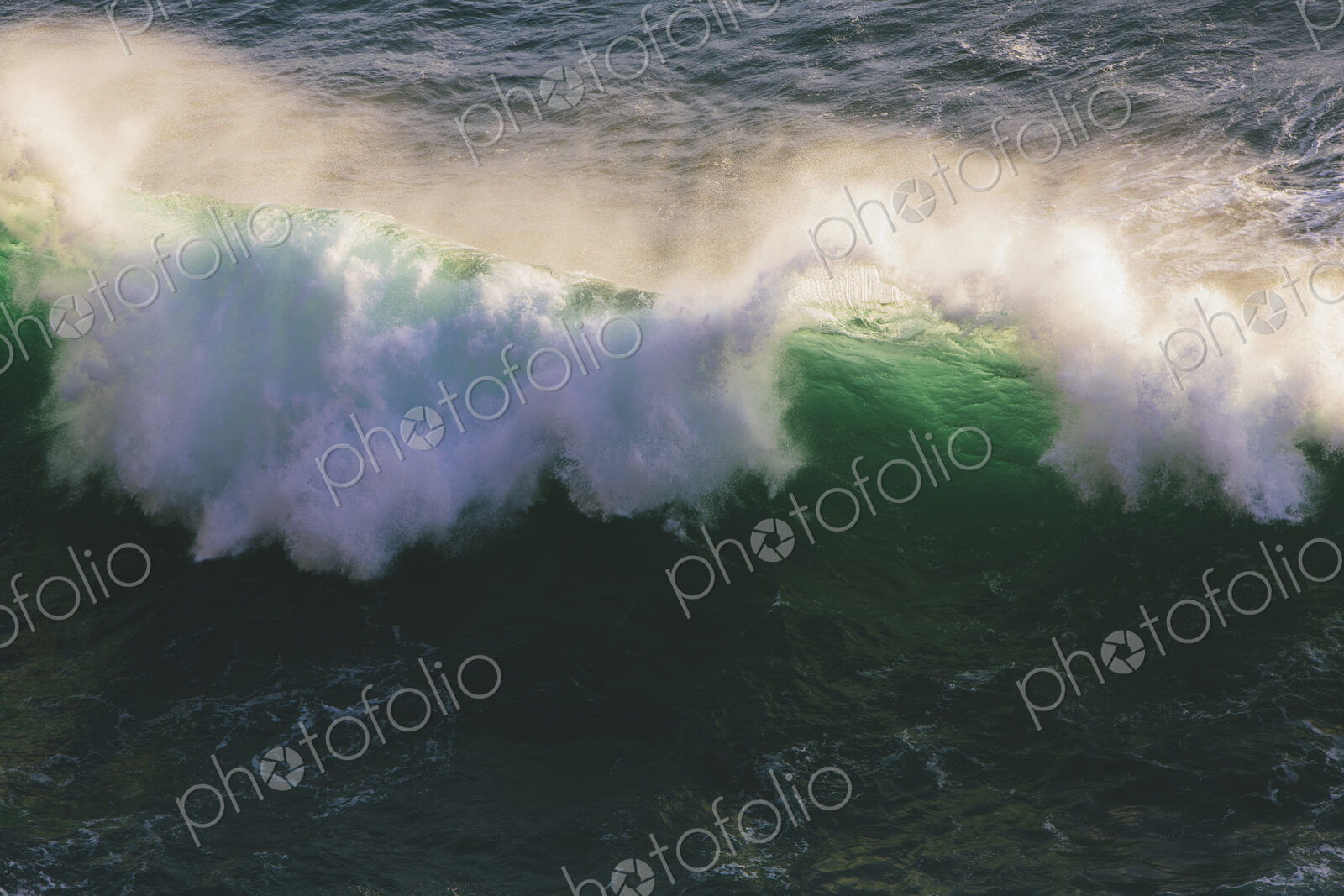 Detail of crashing waves, surf and crest, windblown mist curling from the white water,…
