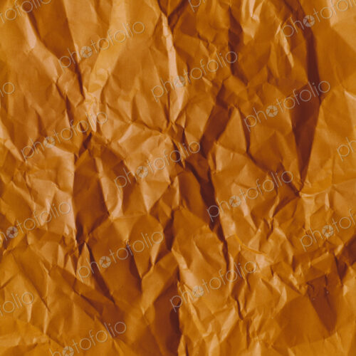Detail of creased and wrinkled orange paper Detail of creased and wrinkled orange paper