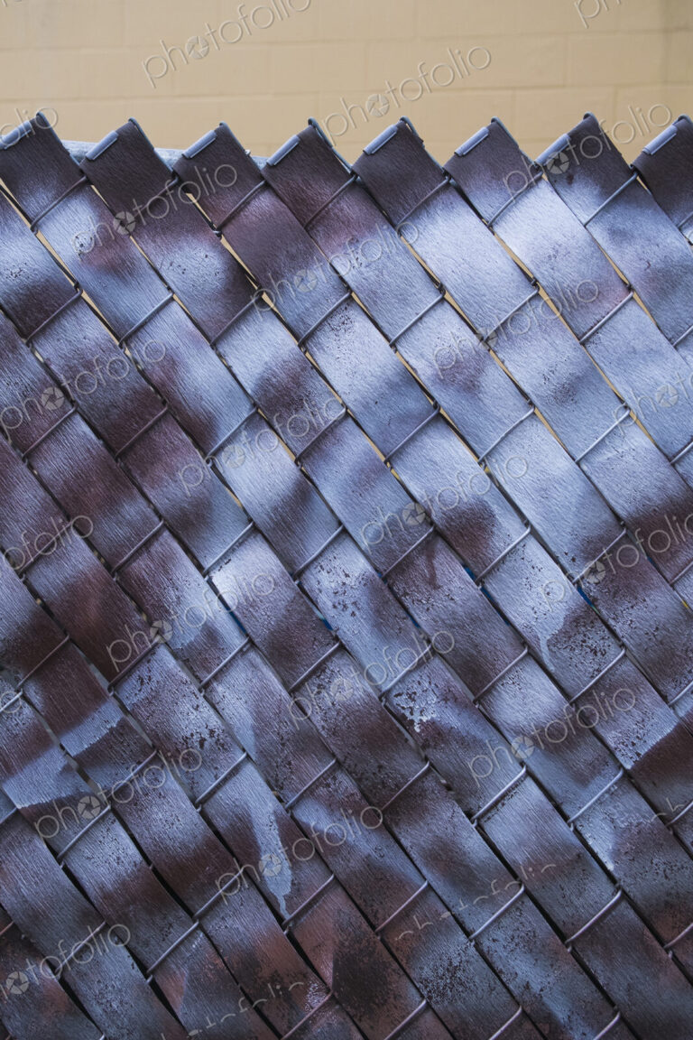 Detail of graffiti paint covering chain-link fence