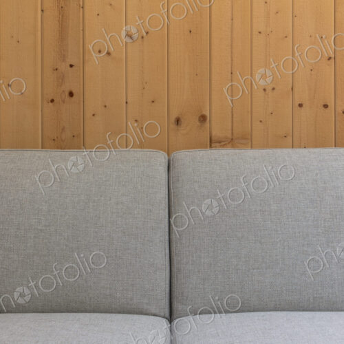 Detail of modern couch against a wood panel wall Detail of modern couch against a wood panel wall