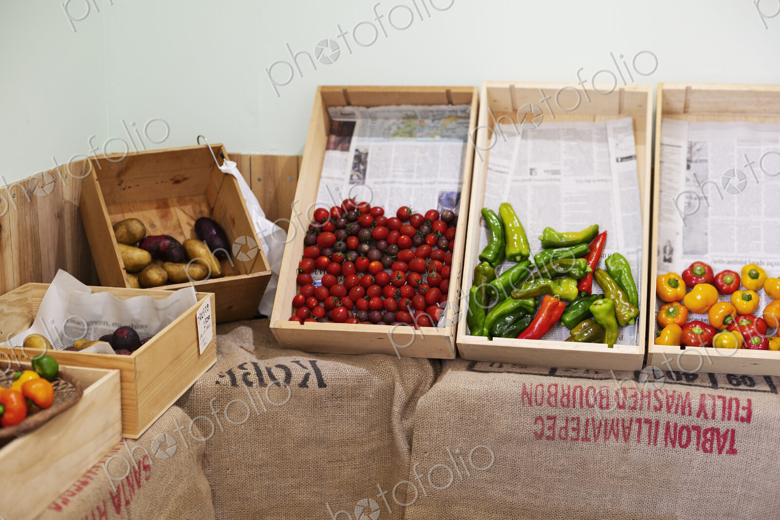 Detail of wooden crates with fresh vegetables in a farm shop.