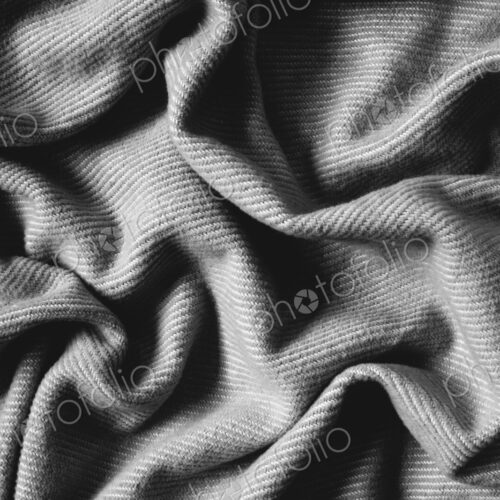 Detail of wrinkles and folds in blanket, overhead view Detail of wrinkles and folds in blanket, overhead view